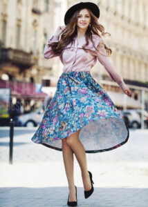 Embrace the beauty of bold florals with this high-low skirt that dances with every step. Perfectly paired with a soft satin blouse for a touch of elegance and flair.
