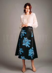 Make a statement with this bold floral skirt, adorned with striking blue accents. Paired with a delicate lace blouse, this look combines modern artistry with timeless sophistication.